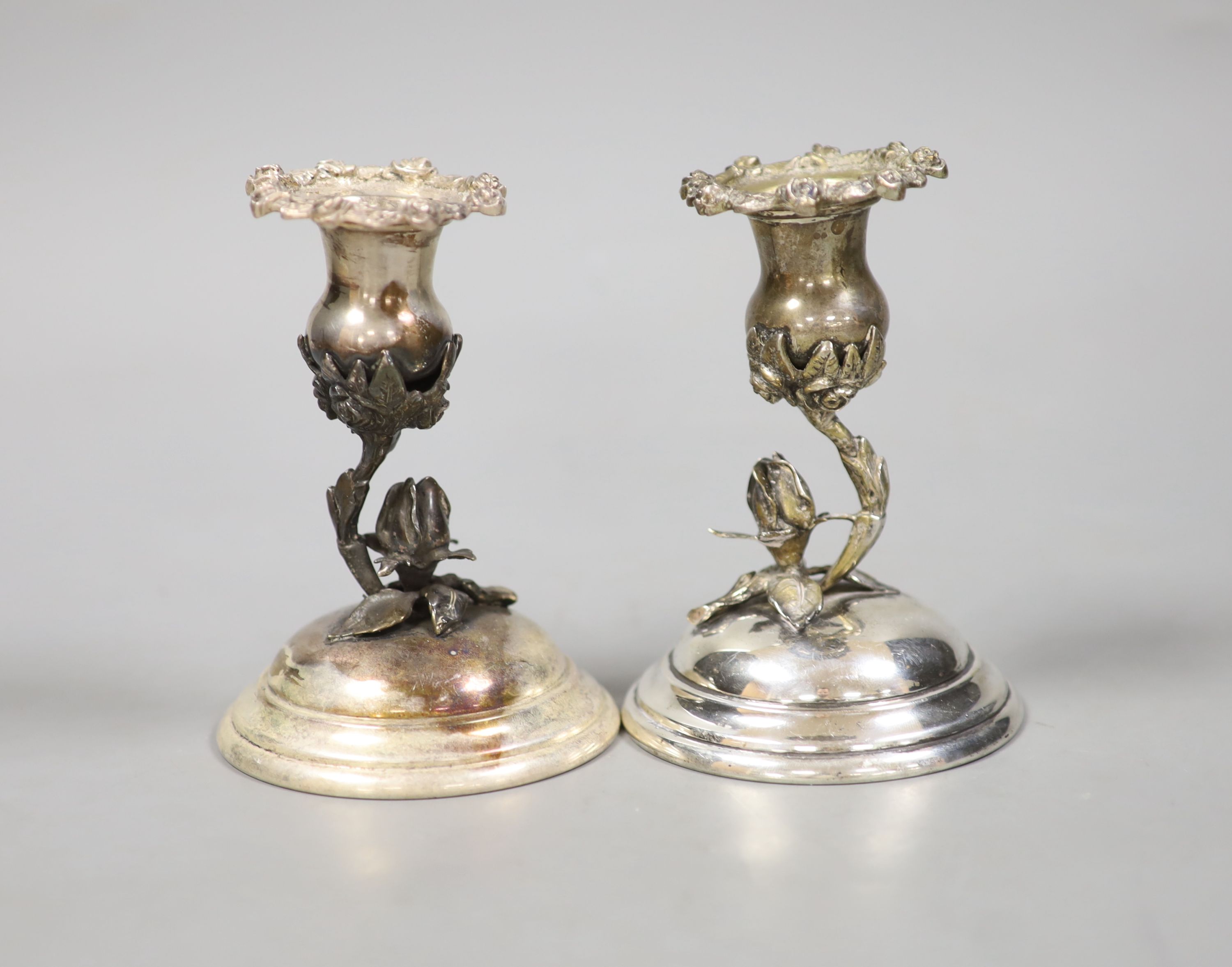 A pair of continental 830 white metal dwarf candlesticks, with foliate stems, height 12.3cm